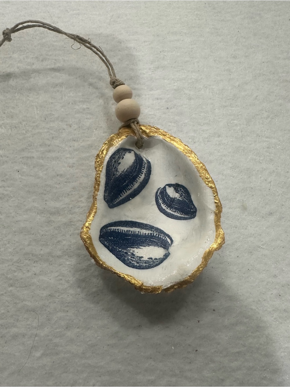 Hand-Painted White and Gold Shell Ornament with Navy Seashell Motif